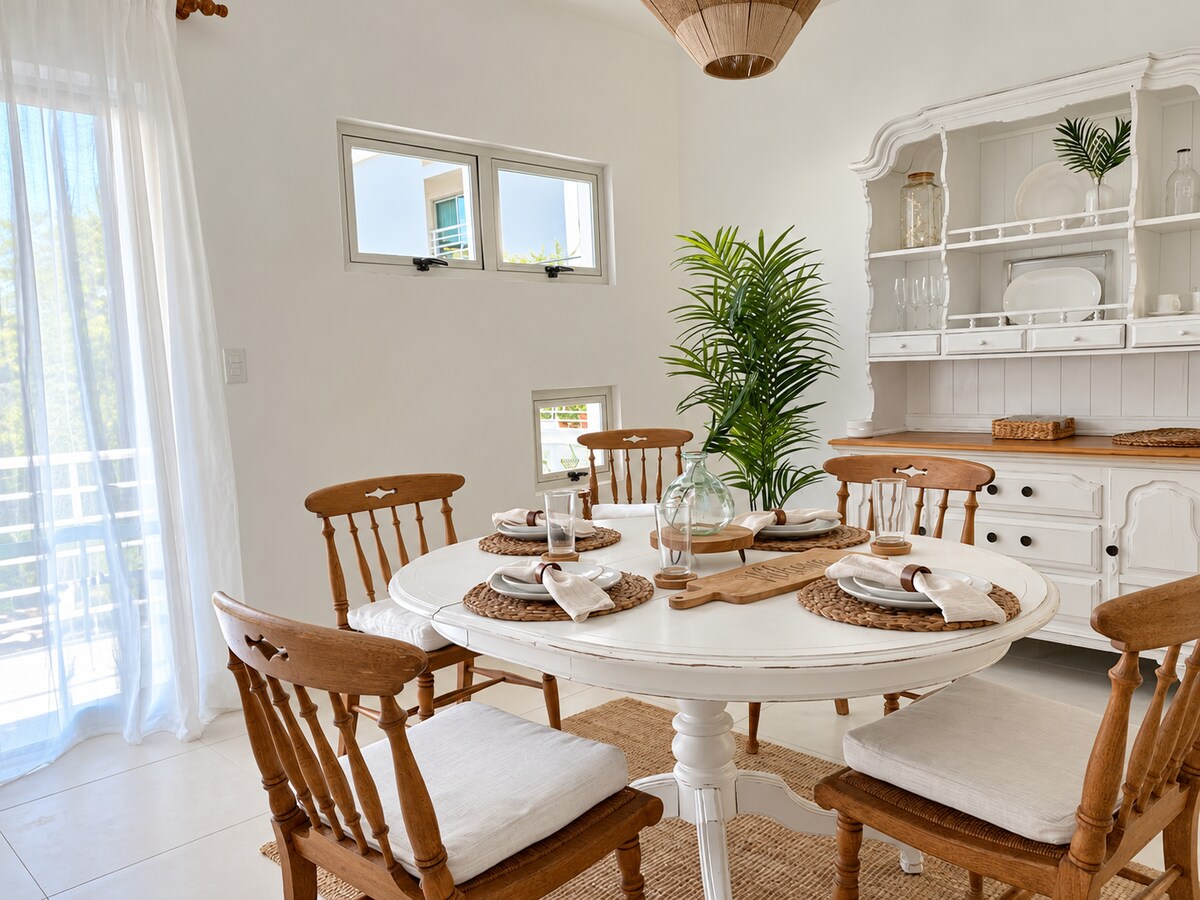 Sunlit dining area seating four guests