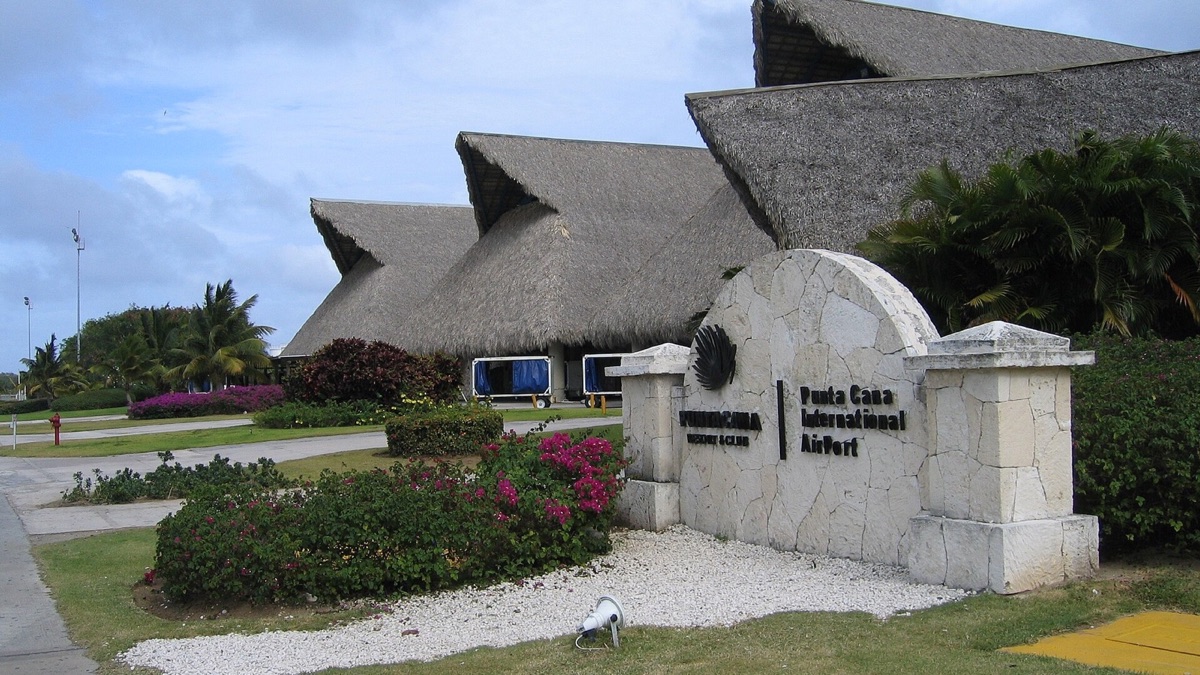 Entrance sign and thatched roofline at Punta Cana International Airport